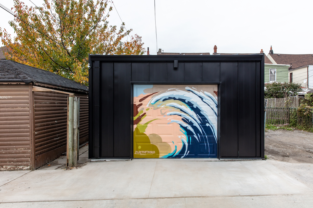 black garage with graffiti mural on door