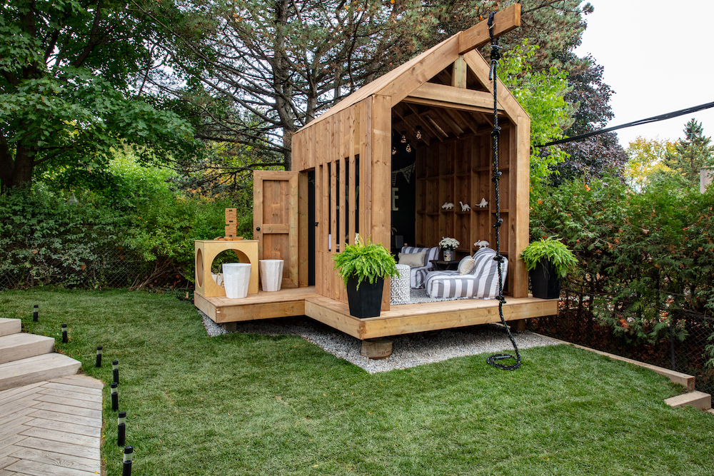 a wooden clubhouse in backyard