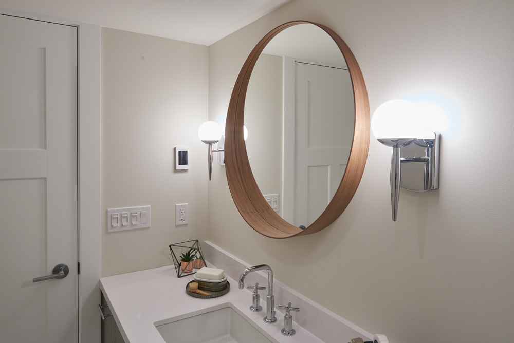 White bathroom with decorative mirror
