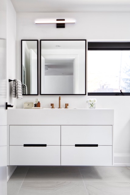 Wall-mounted vanity in streamlined white bathroom