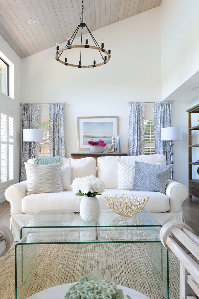 facing white slipcovered sofa behind clear nesting coffee tables