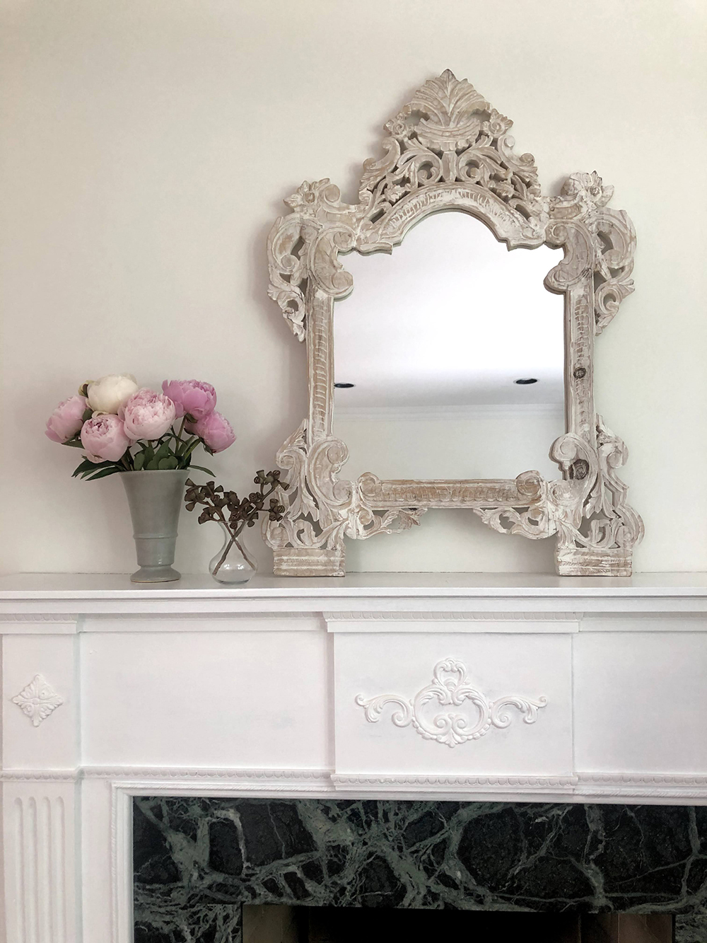 Fireplace with pink flowers on mantel
