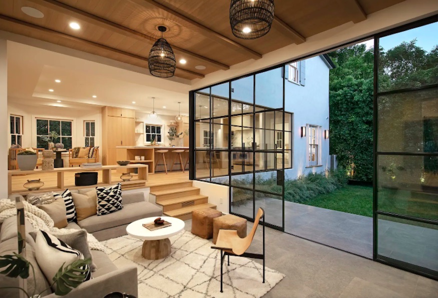 Steel-framed floor-to-ceiling glass doors that look out onto the backyard deck