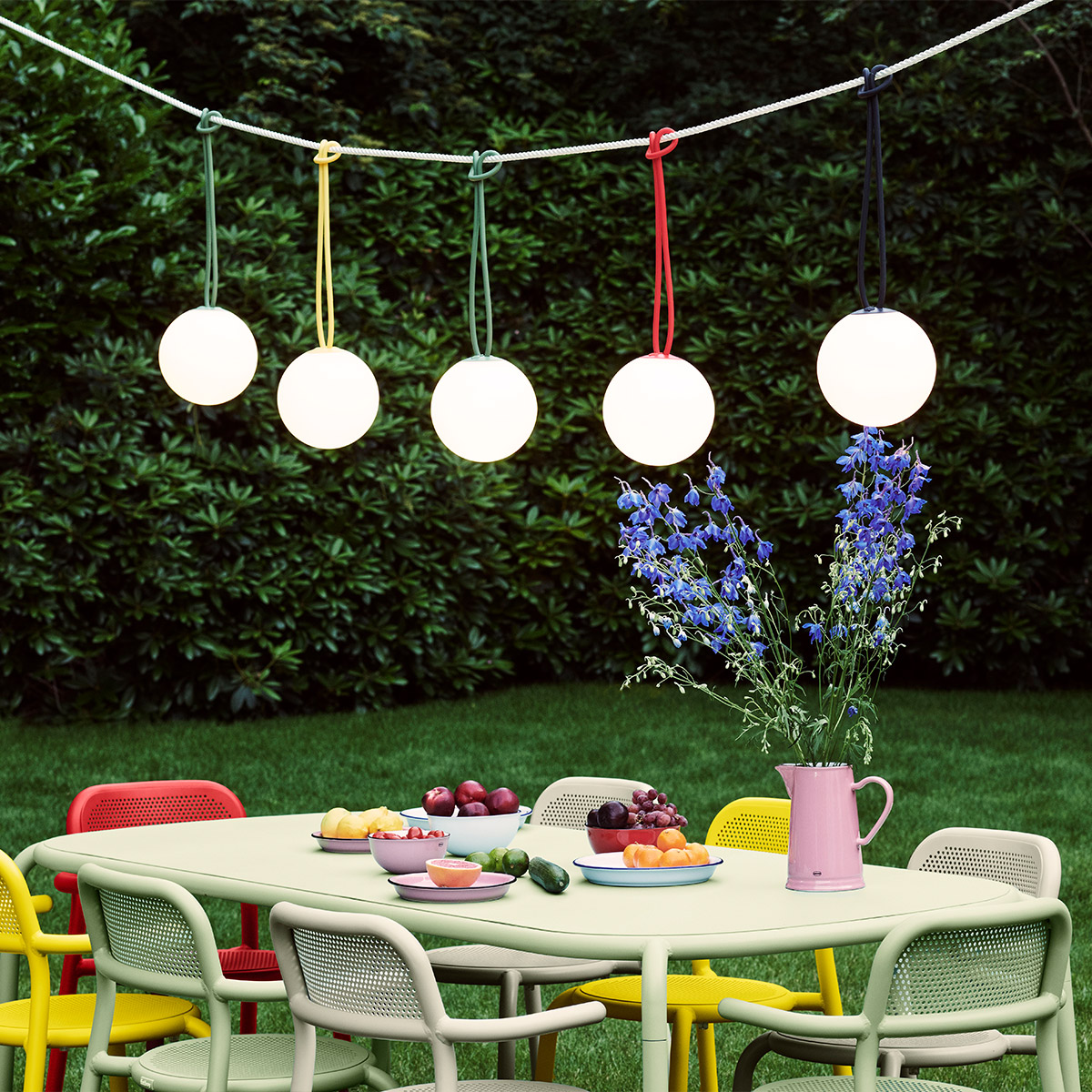 Hanging globe lamps over outdoor table