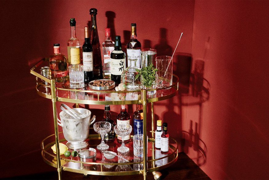 Bar cart with glasses and liquor bottles
