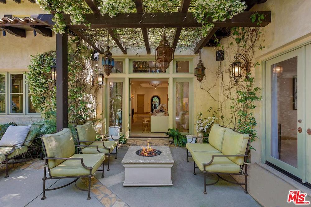 Outdoor patio with fire pit and climbing vines