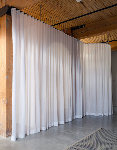 Curtains hiding millwork box in Broadview Loft from StudioAC