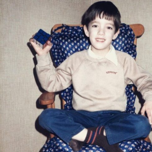 Jonathan Scott as a child with a Rubik's cube