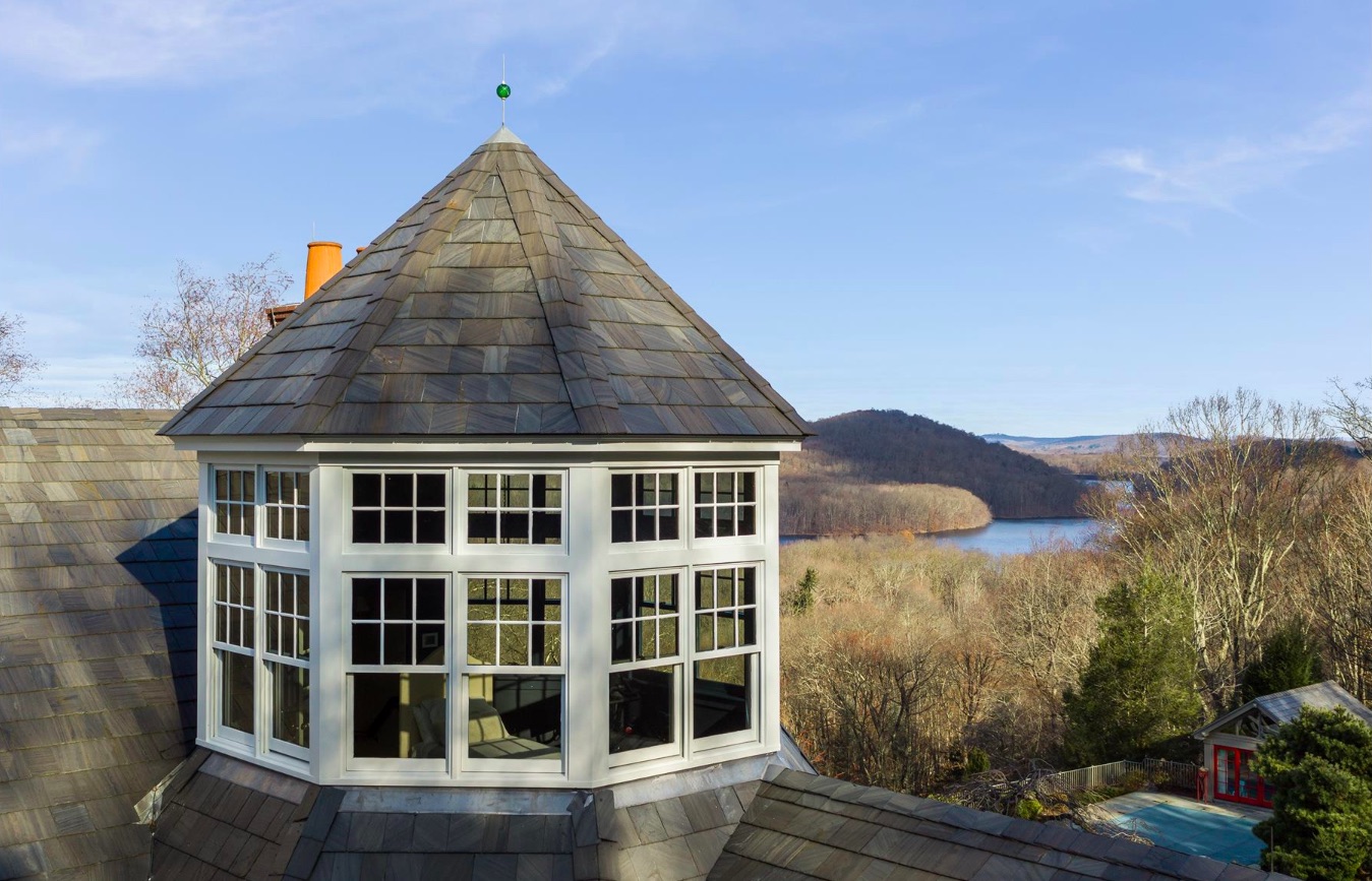 An exterior shot of the turret with a view of the wooded area and lake