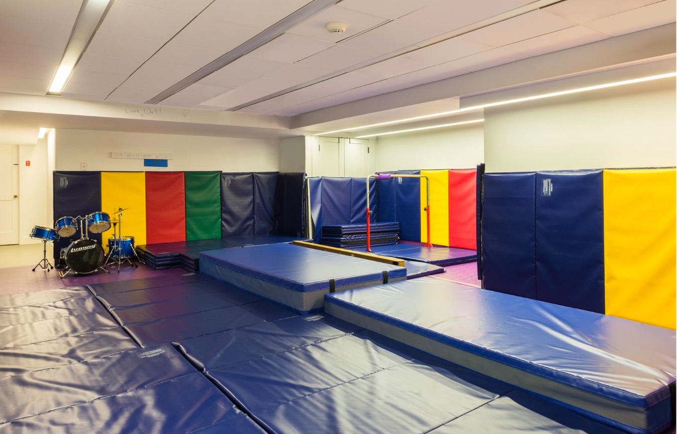 A large children's playroom with plenty of brightly coloured padded mats