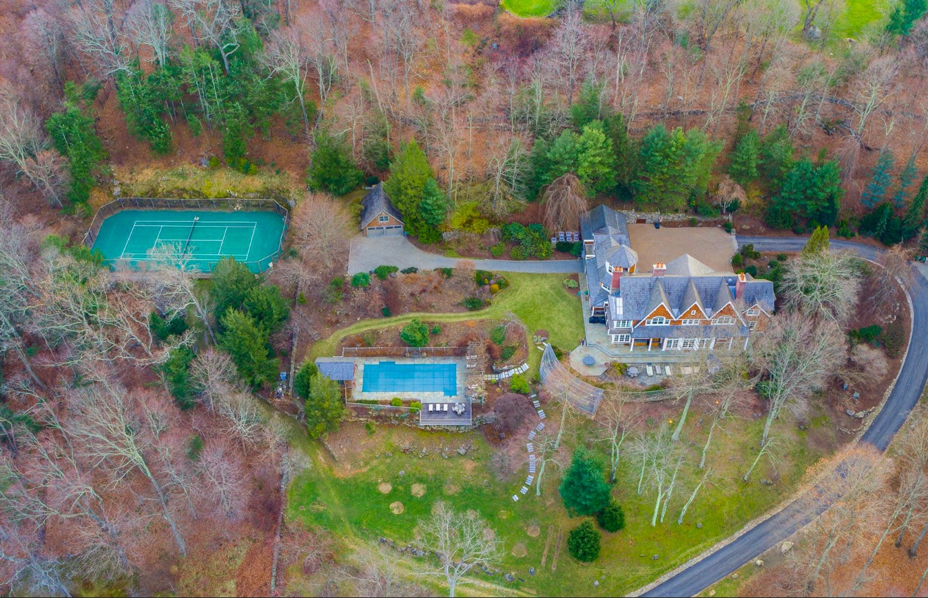 An aerial view of the entire property, including tennis court and outdoor pool