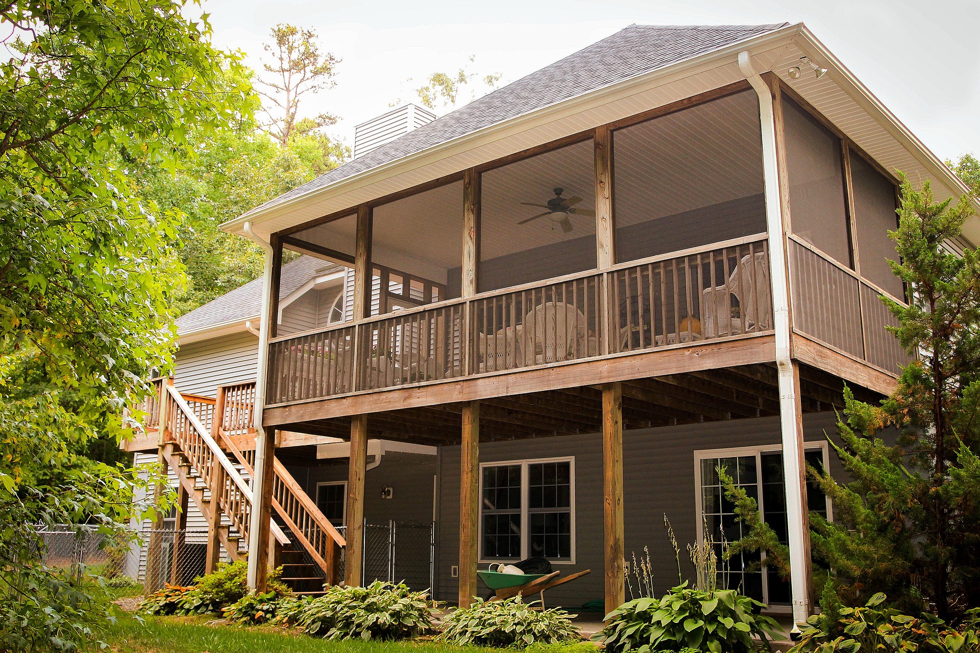 View of rear view of house showing wooden deck and patio