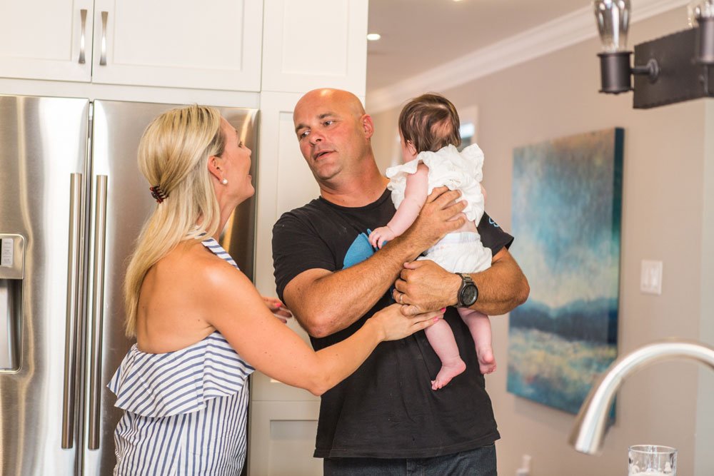 Bryan and Sarah Baeumler With Their Client's Child