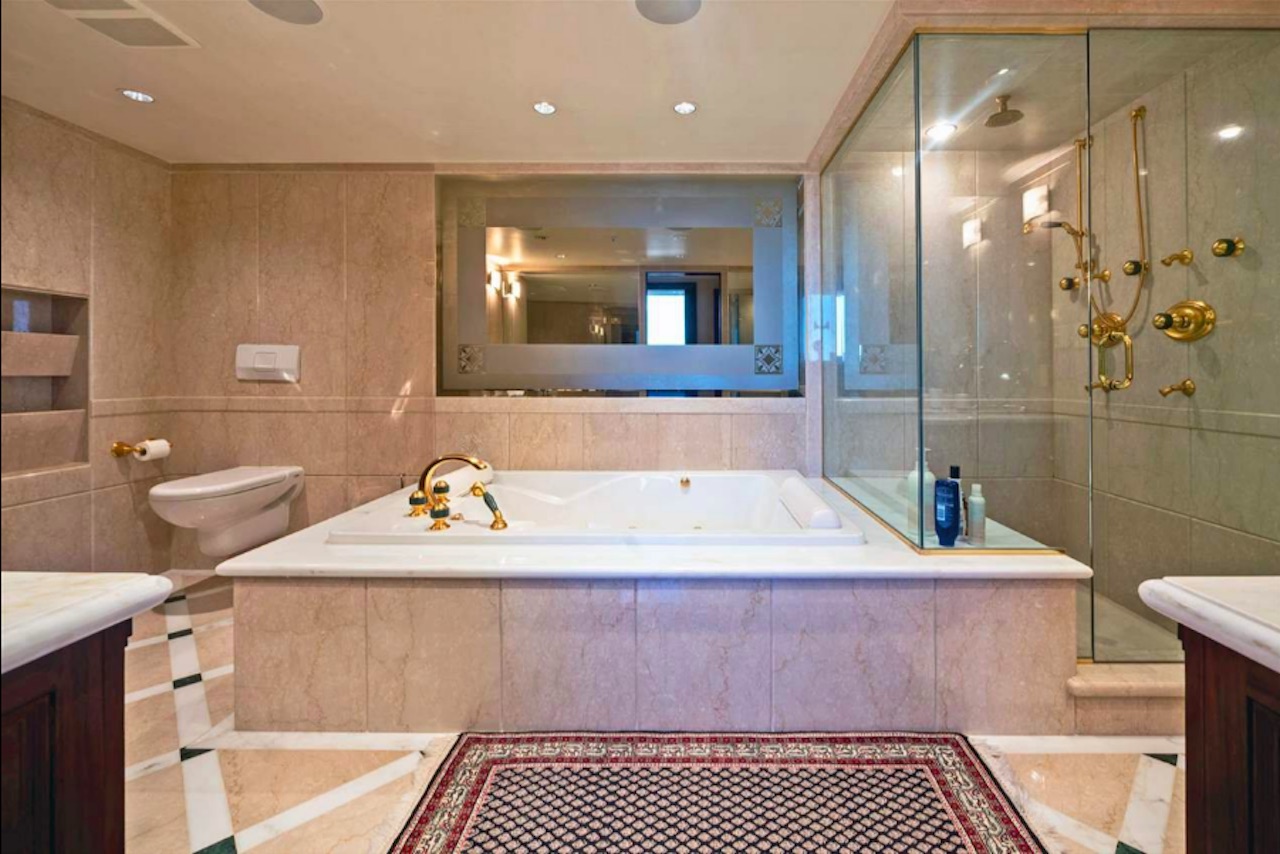 master bathroom with a giant-sized soaker tub and glass-enclosed steam shower