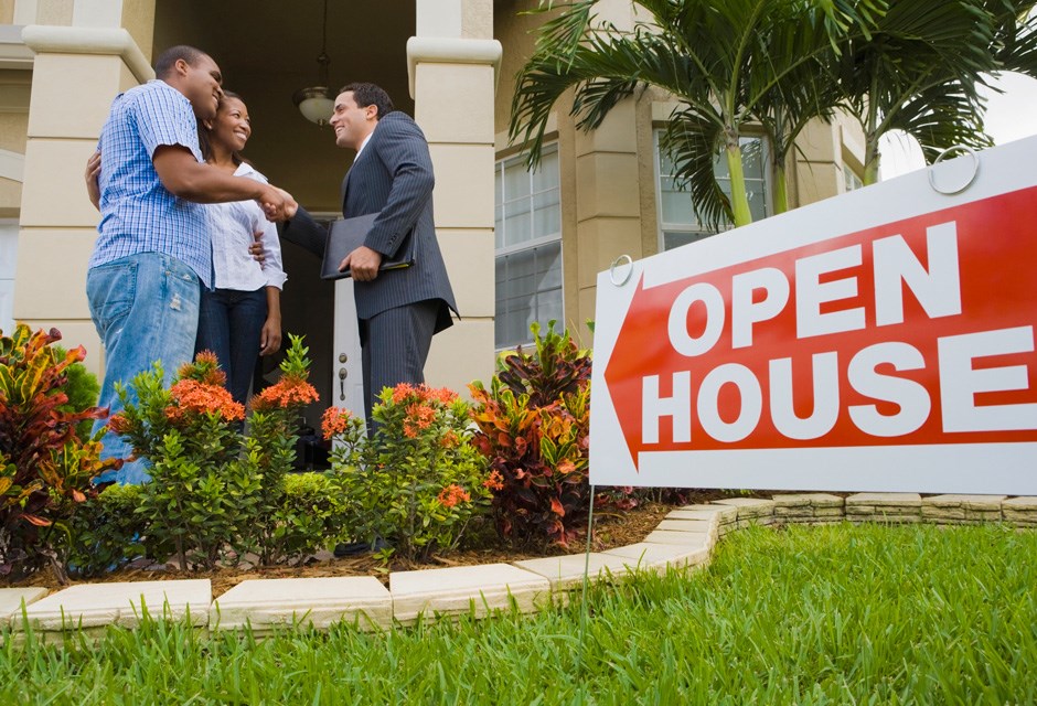 Couple and real estate agent at open house