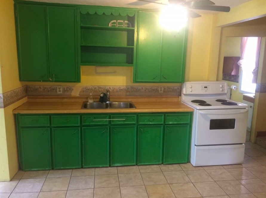 outdated kitchen with bright green cabinets