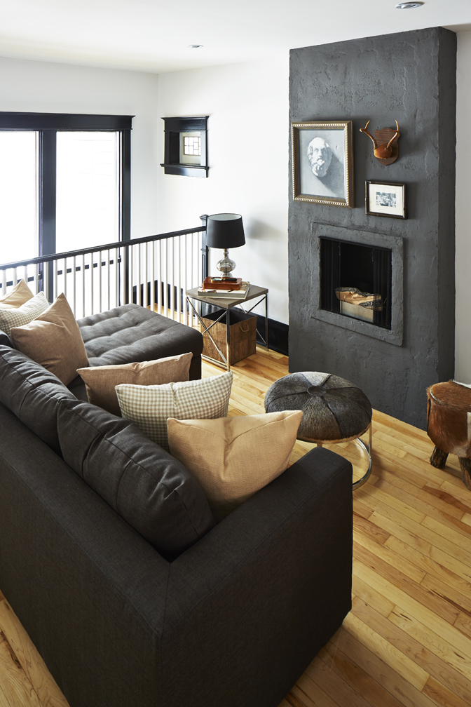 Charcoal grey living room design with hits of warm wood.
