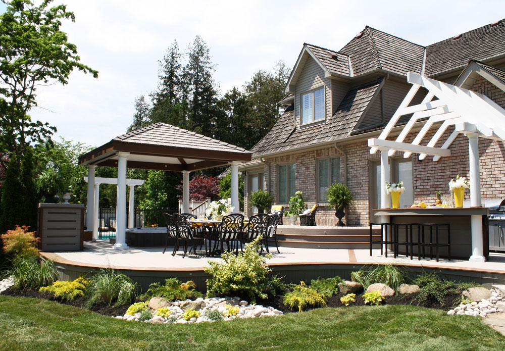 Elegant backyard design where garden beautifully mimics the deck line.