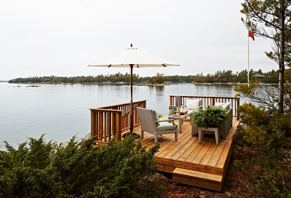 Dreamy dock with comfy sofa, two chairs, a coffee table and side tables.