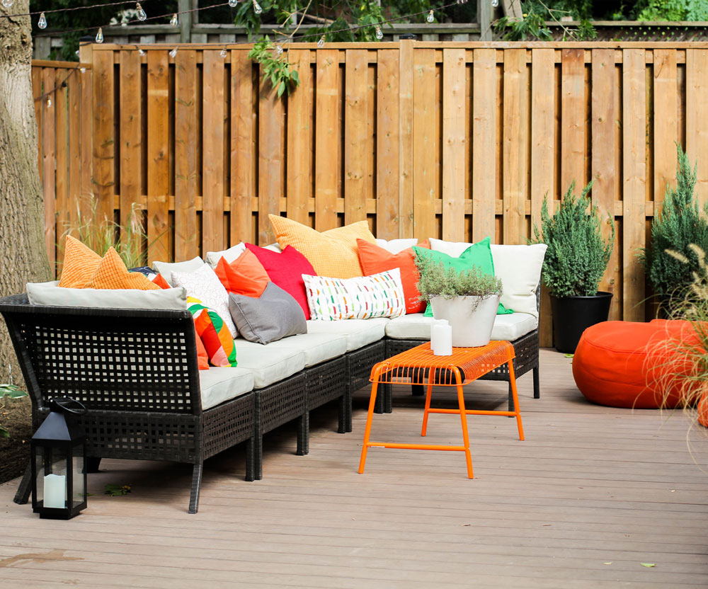 Outdoor patio sectional with bright, cheerful furniture accents.