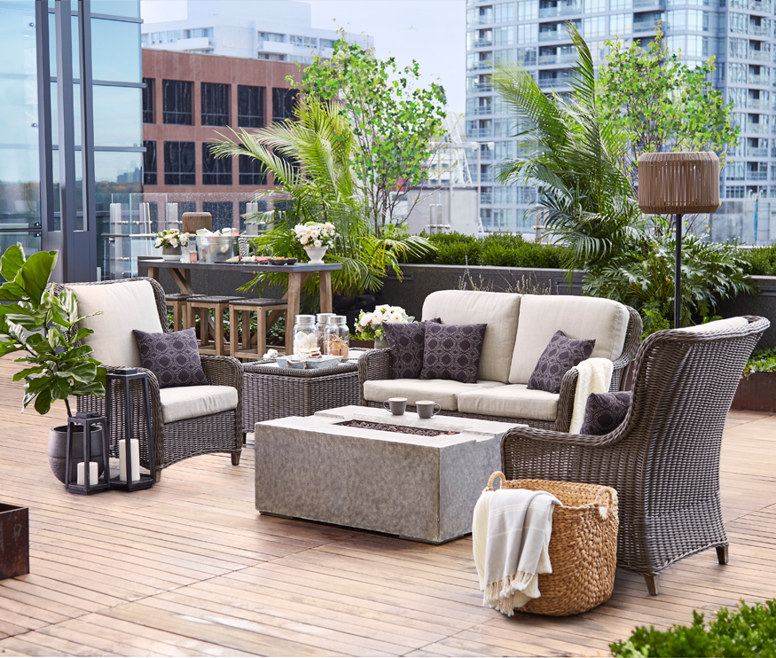Stylish condo patio with lounge furniture, a fireplace and trendy accents.