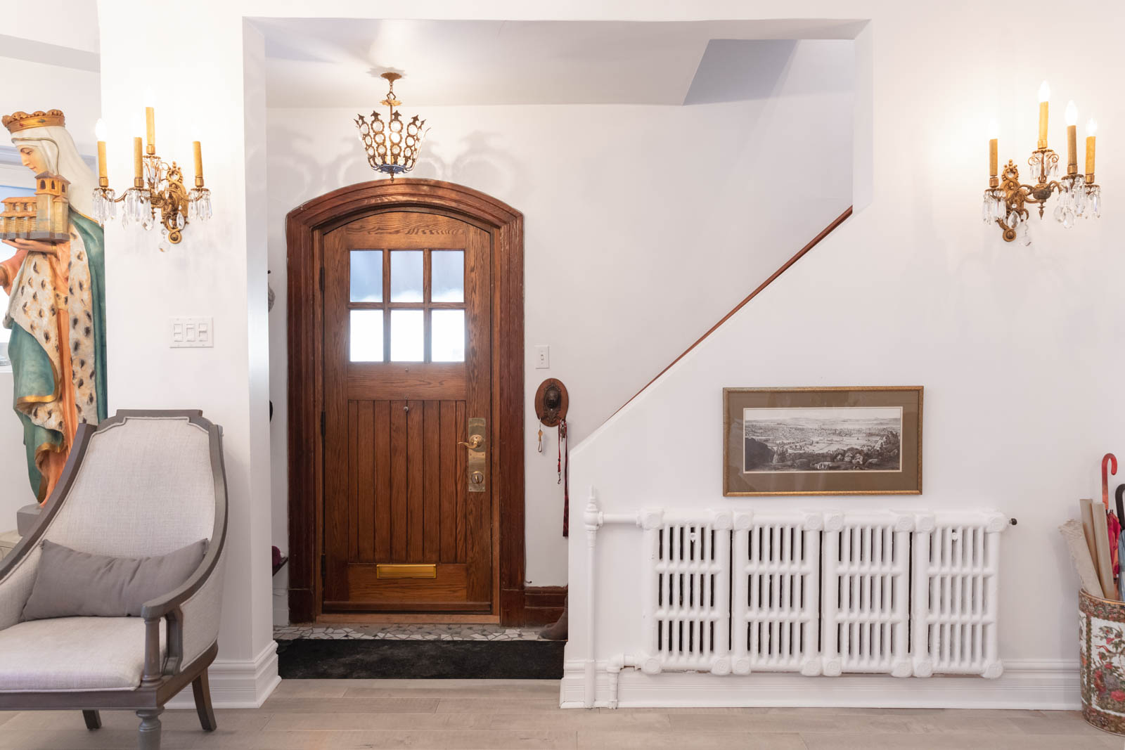 A spacious entryway with a custom-designed Victorian front door