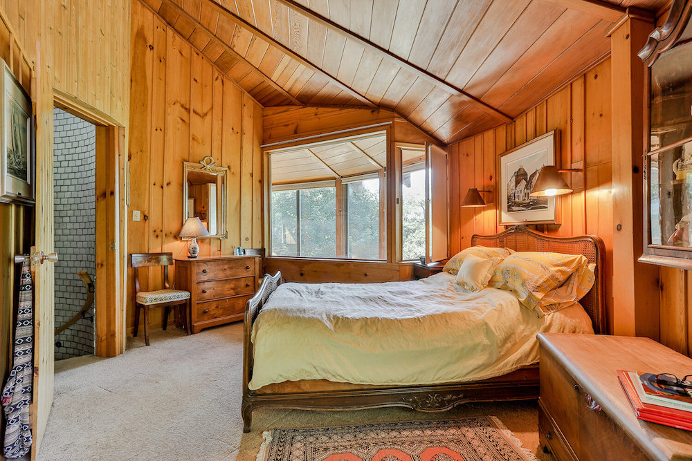 Bedroom with wood walls