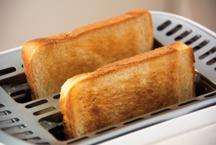 Two pieces of toast in a toaster