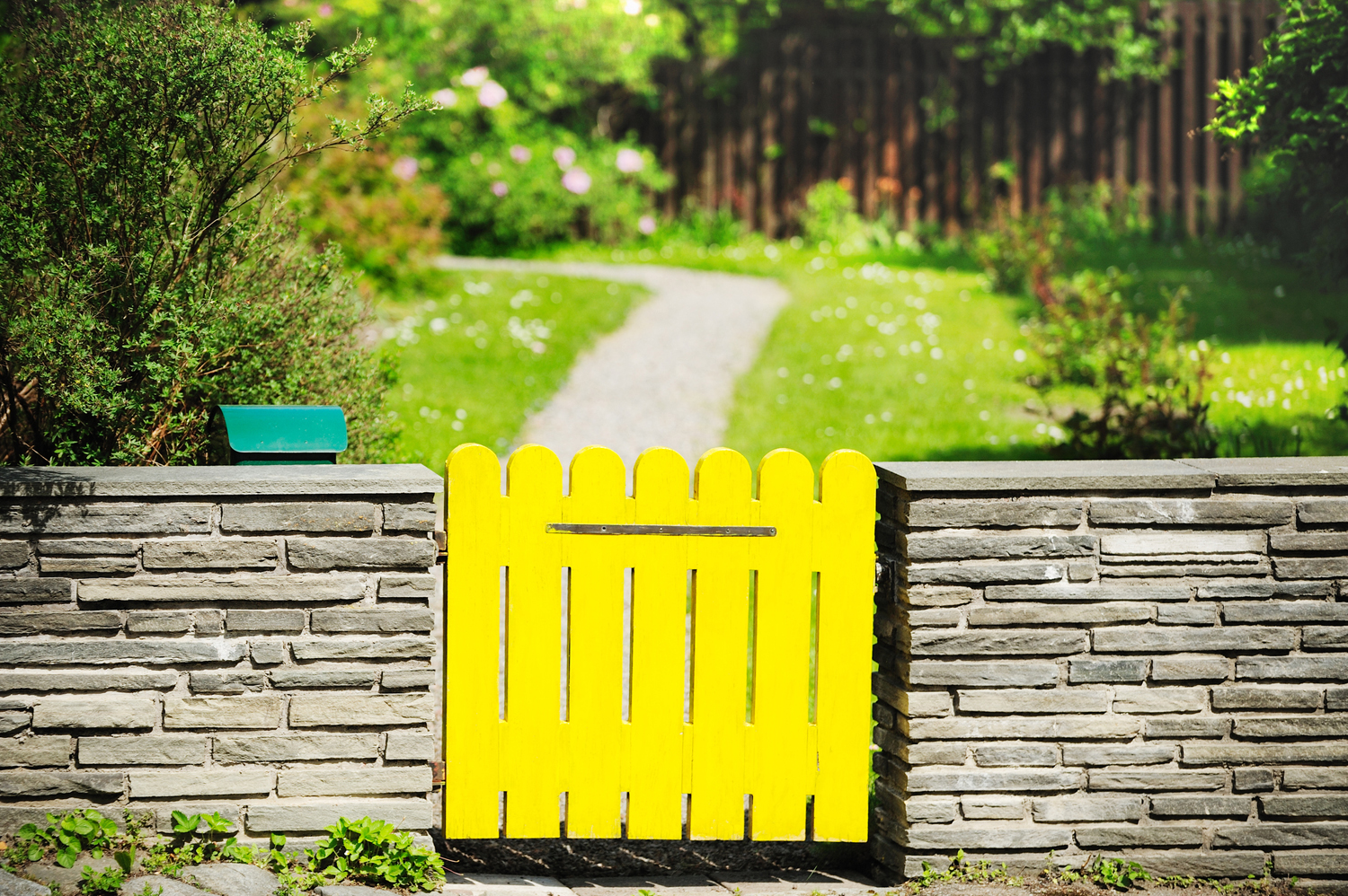 Yellow fence leading to garden