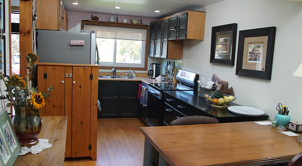 A dated 1970s kitchen with wood details and an awkward set up.