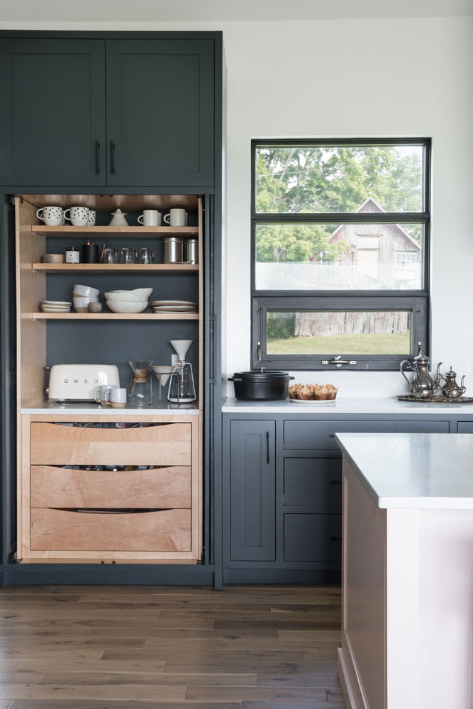 black kitchen shelving with exposed pale wood pantry and three drawers