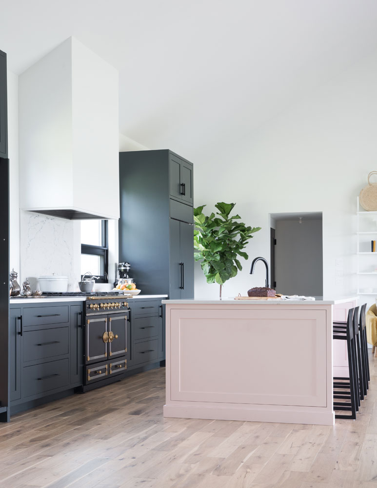 kitchen with black and gold oven and pink island on right