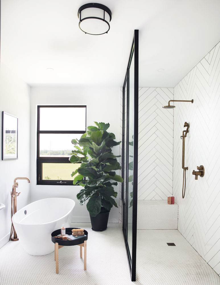 bathroom with vessel tub on left, walk-in shower with white chevron subway tiles walls on right