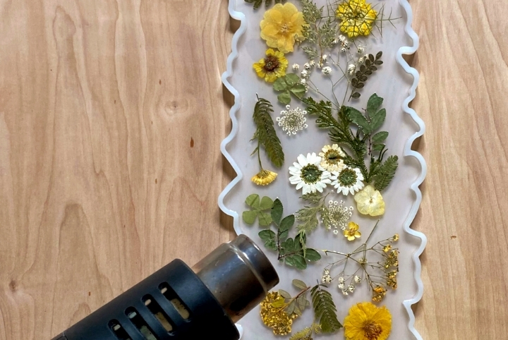 A heat tool being used for a floral DIY tray