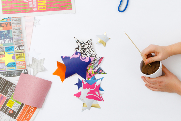 A shot of hands crafting with cut out stars from scrap papers