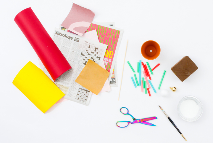 A flat lay of crafting materials including papers, scissors, glue and more