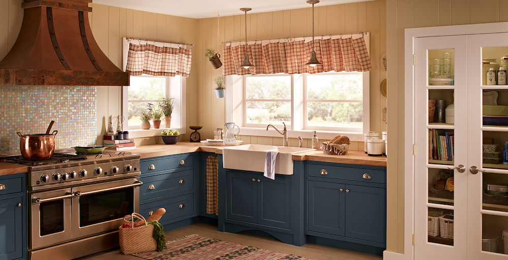 cozy kitchen with blue cabinets, beige walls and white accents