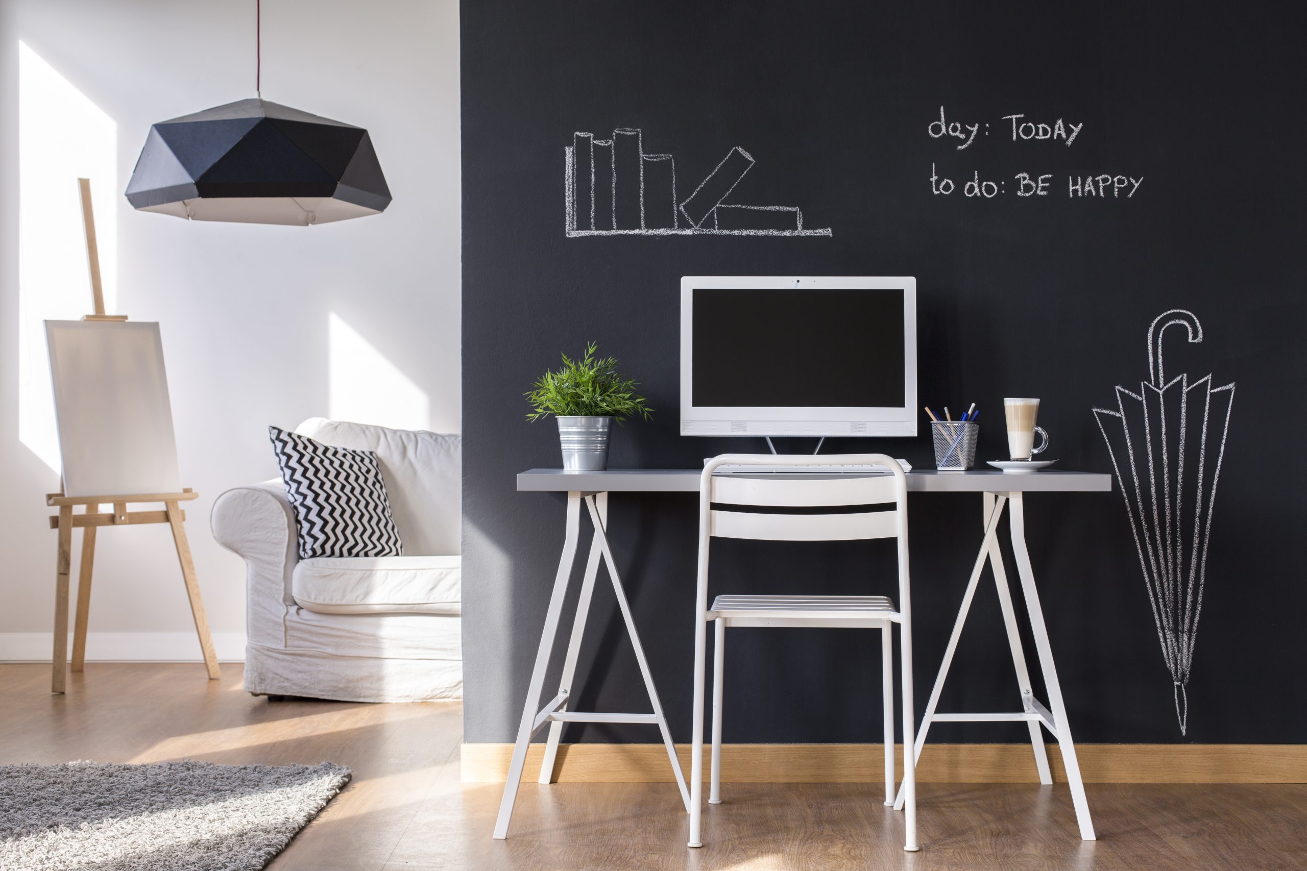Minimalist modern work space at home with blackboard wall