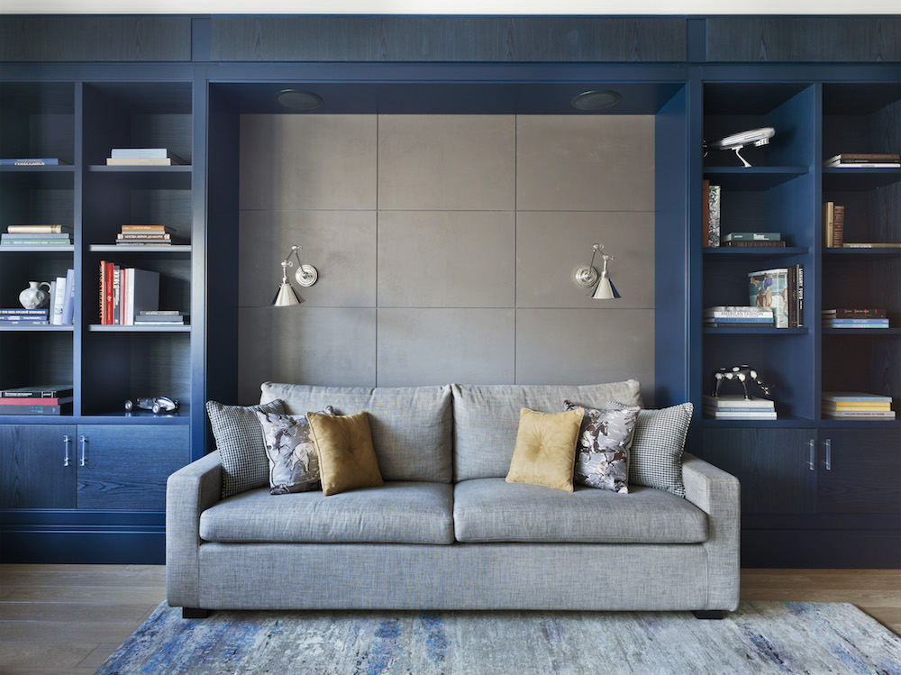 living room with navy blue wall unit