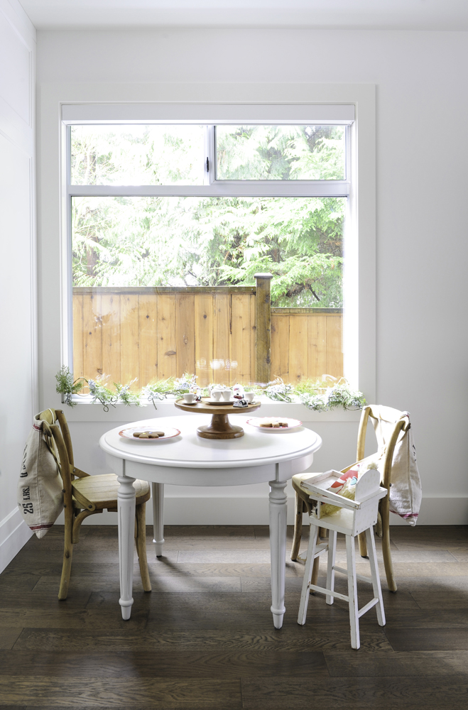White kids' table and chairs in front of kitchen window