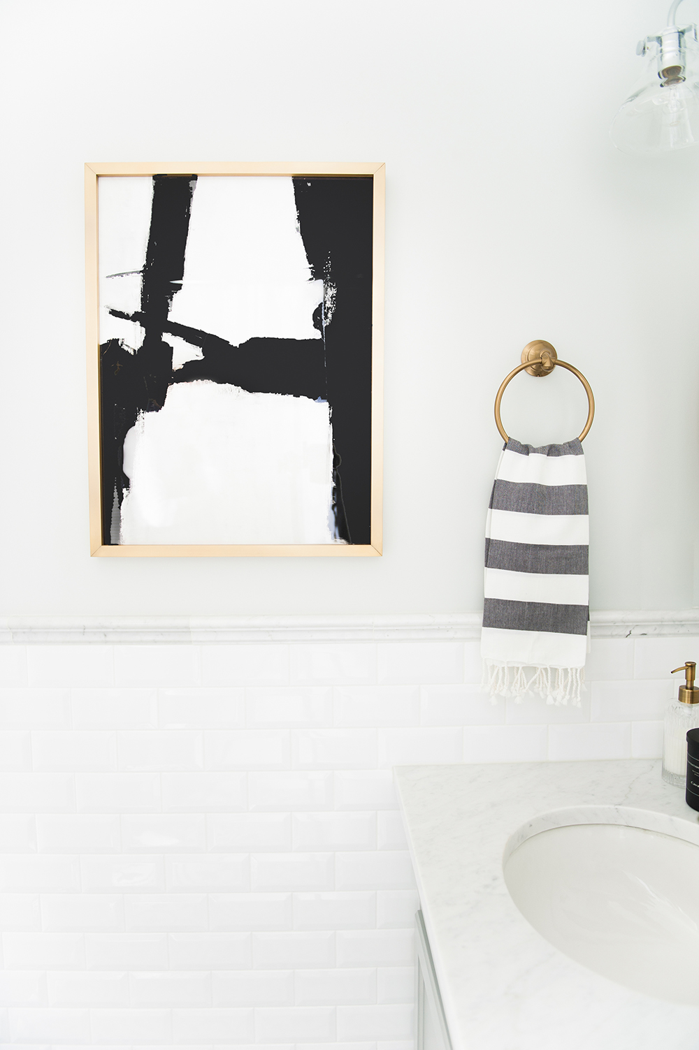 Black and gold accents add interest to this small bathroom.