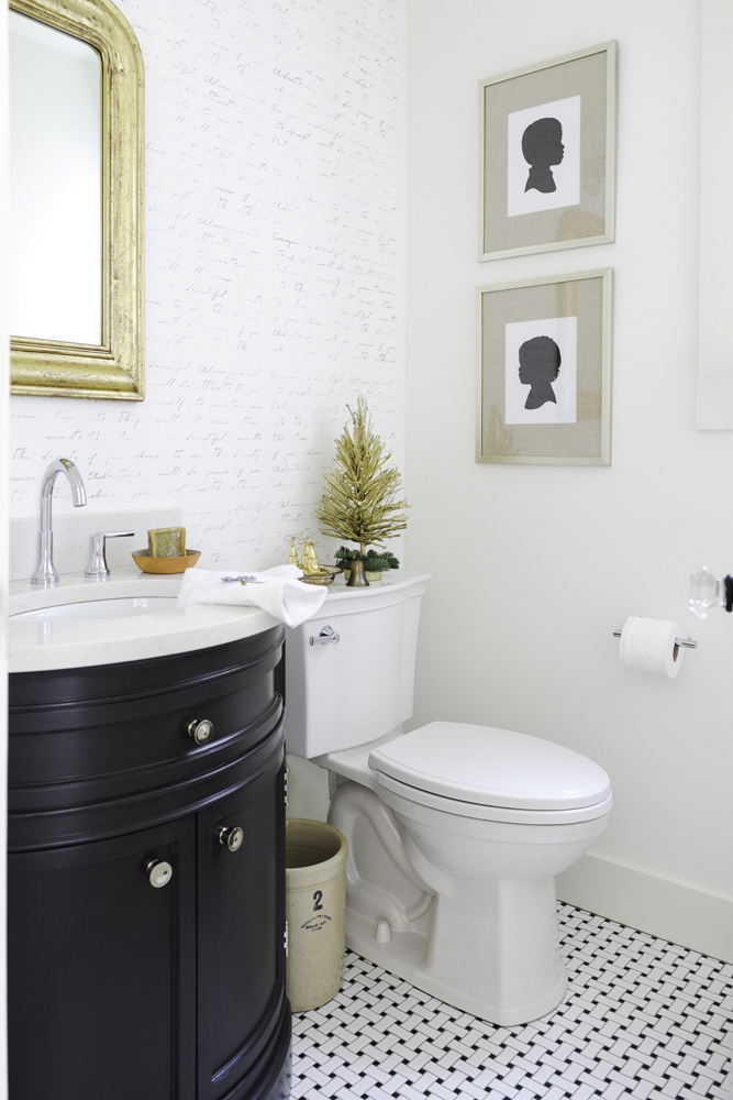 Vintage-inspired powder room with elegant feature wall and holiday touches.