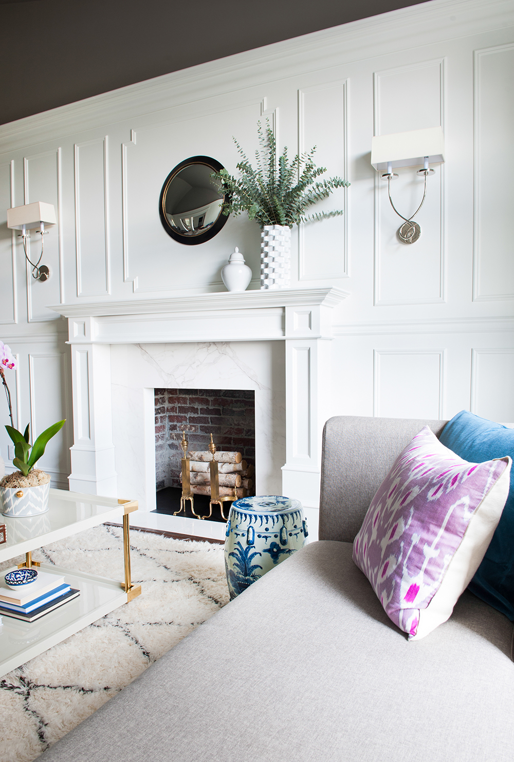 An original fireplace updated with modern marble and fresh paint.