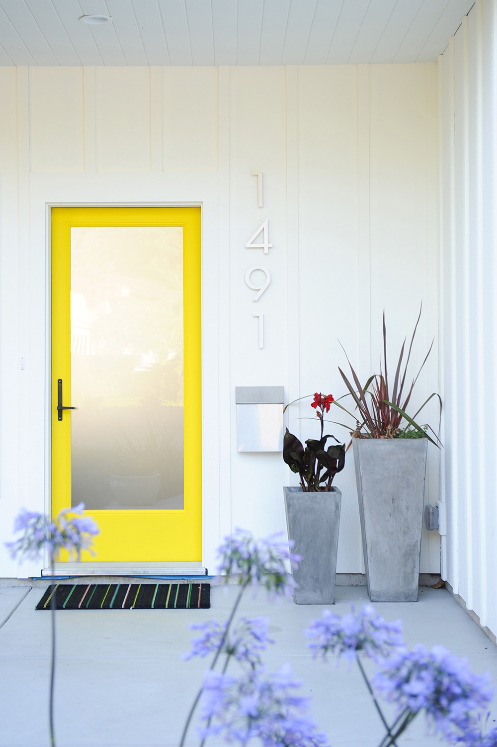 The electric-yellow front door is a nod to the family's favourite vacation spot.