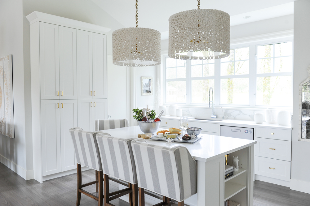 Kitchen island with striped stools and pendant lights