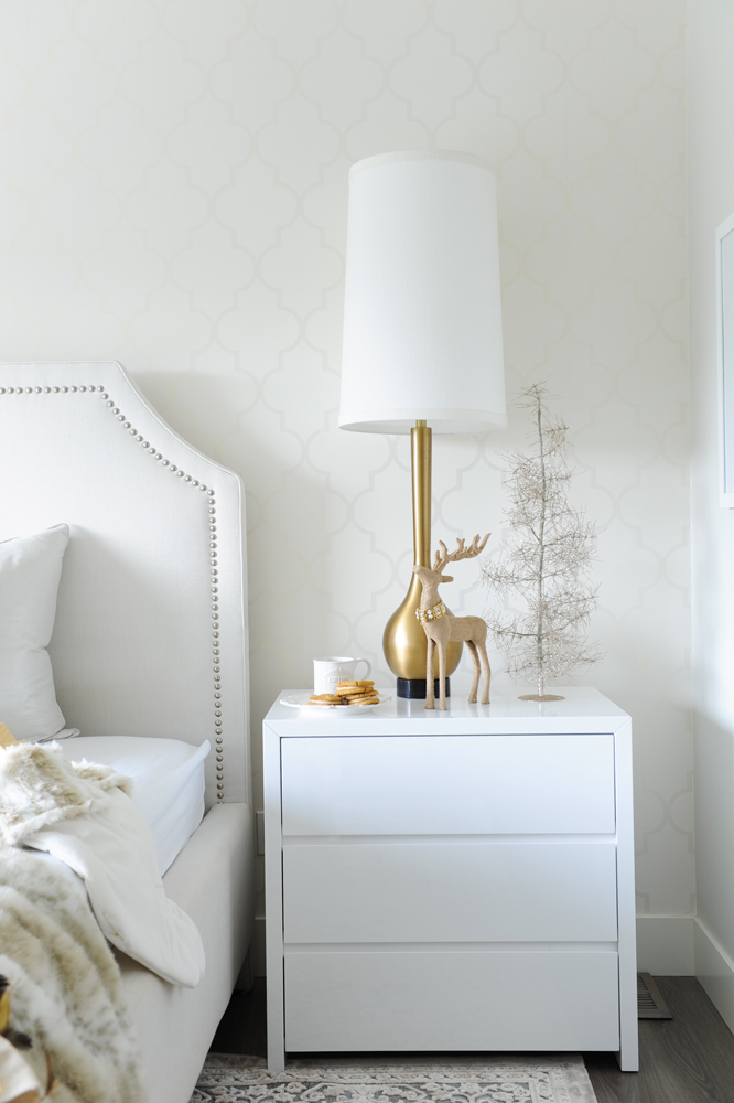 side table and lamp in master bedroom with reindeer and tree