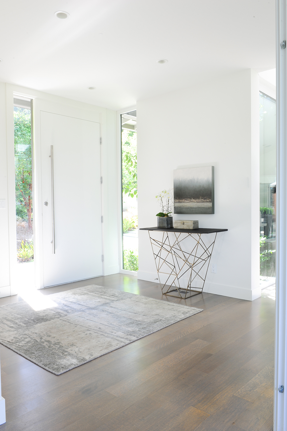 bright and airy front entrance with sleek console table and artwork.