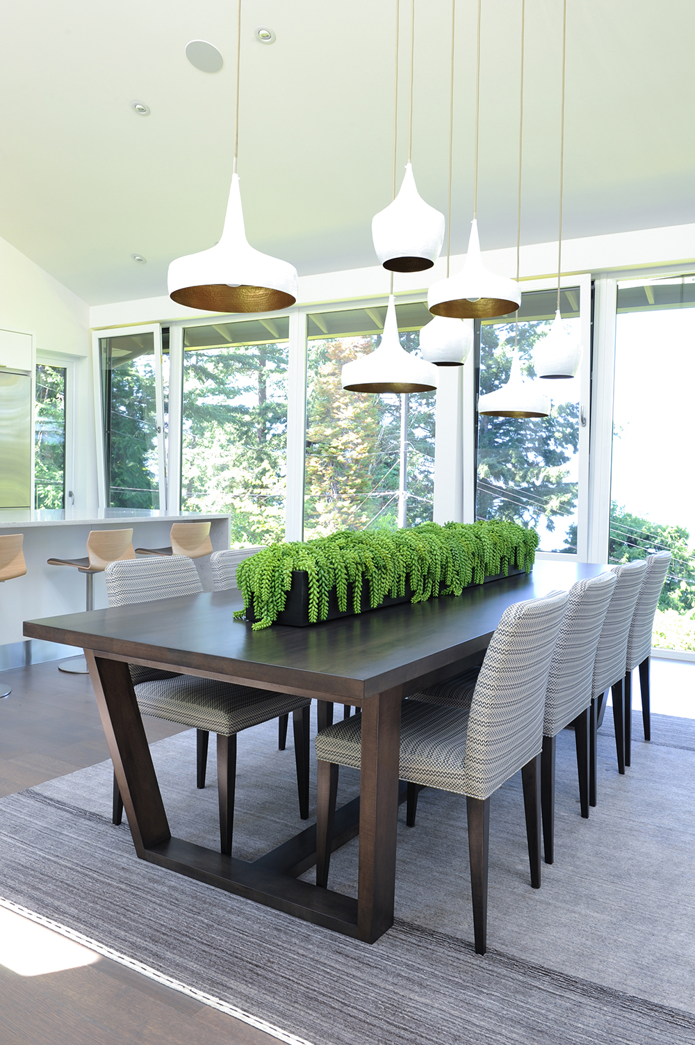 Nature-inspired dining area with gorgeous pendant lights.