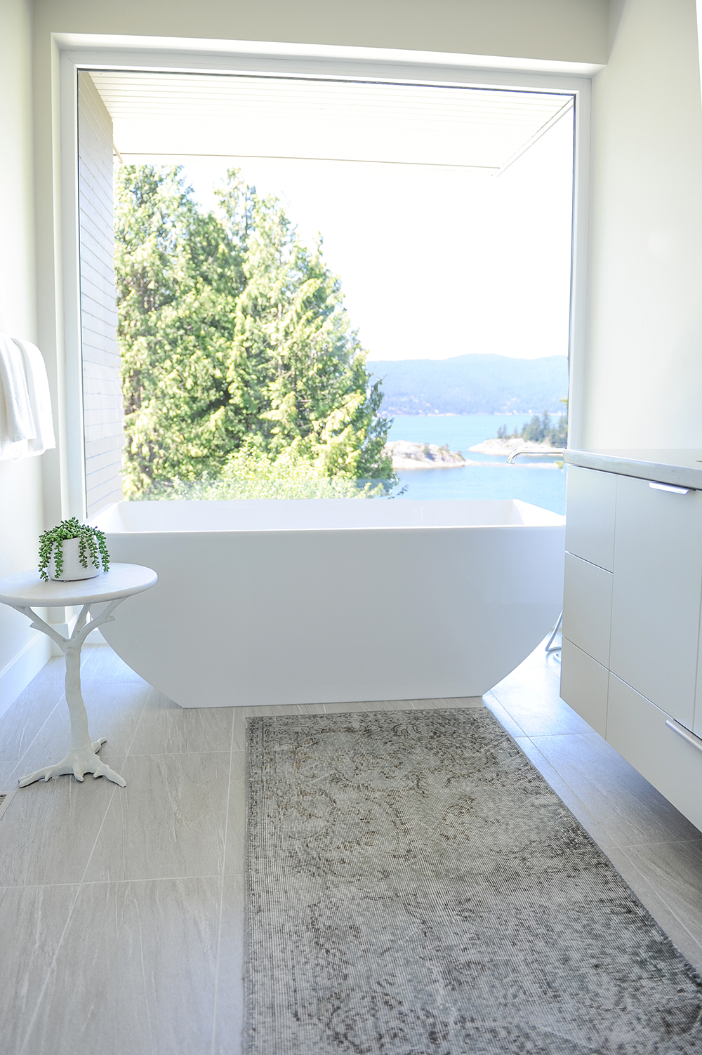 This show-stopping master ensuite features a sleek vessel tub.