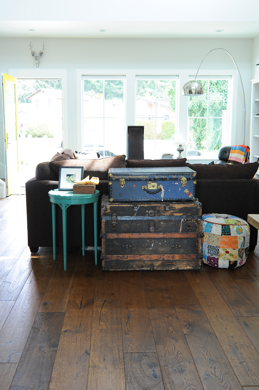 Furnishings with meaning, like these thrift-shop trunks, are layered throughout the space.